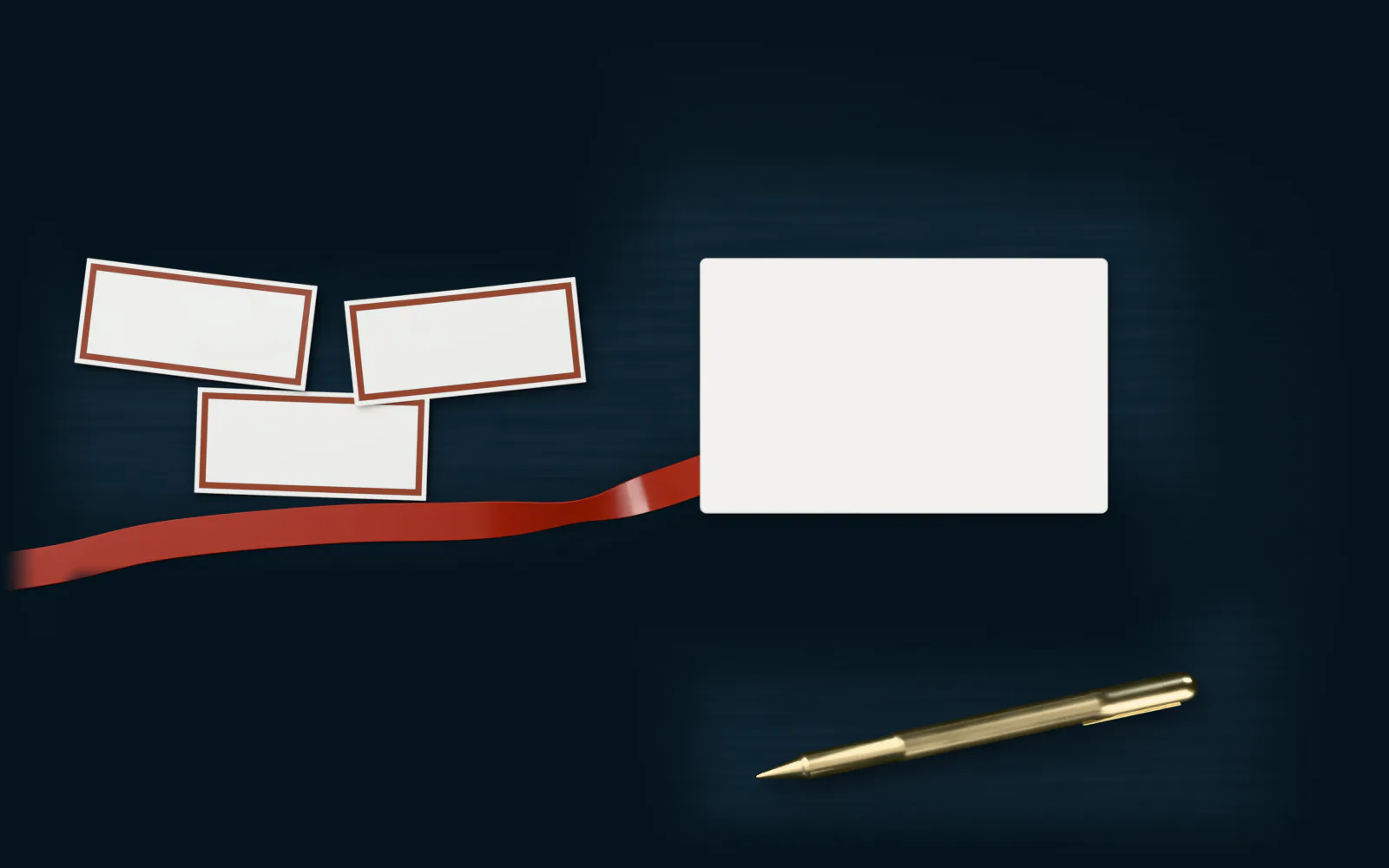 A desk in soft light: a few small cards, a pen, and the red line as a ribbon running to a blank printed card.